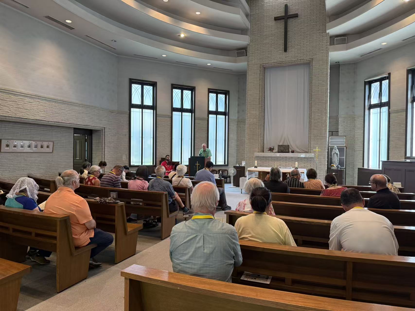Pilgrims seated for prayer inside a Catholic church in Japan