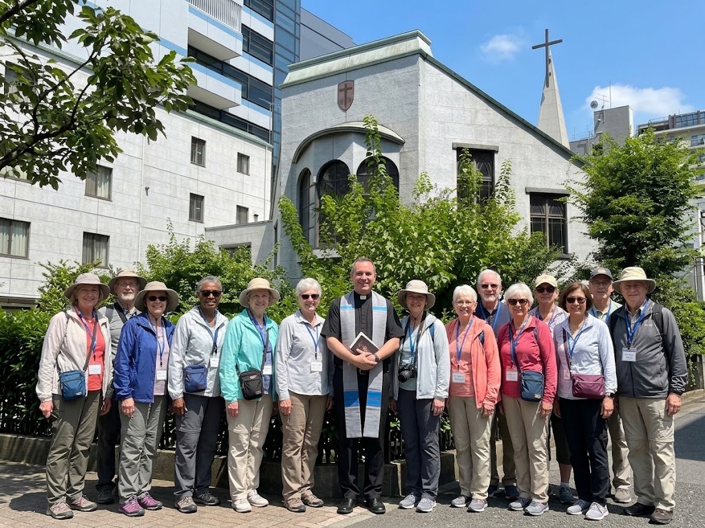 Pilgrimage group with a priest outside a Catholic church in Japan